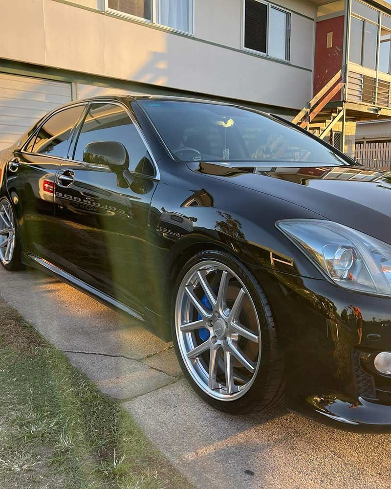 A Black Car is Parked in Front of a Building — Best Car Detailing in Vincent, QLD