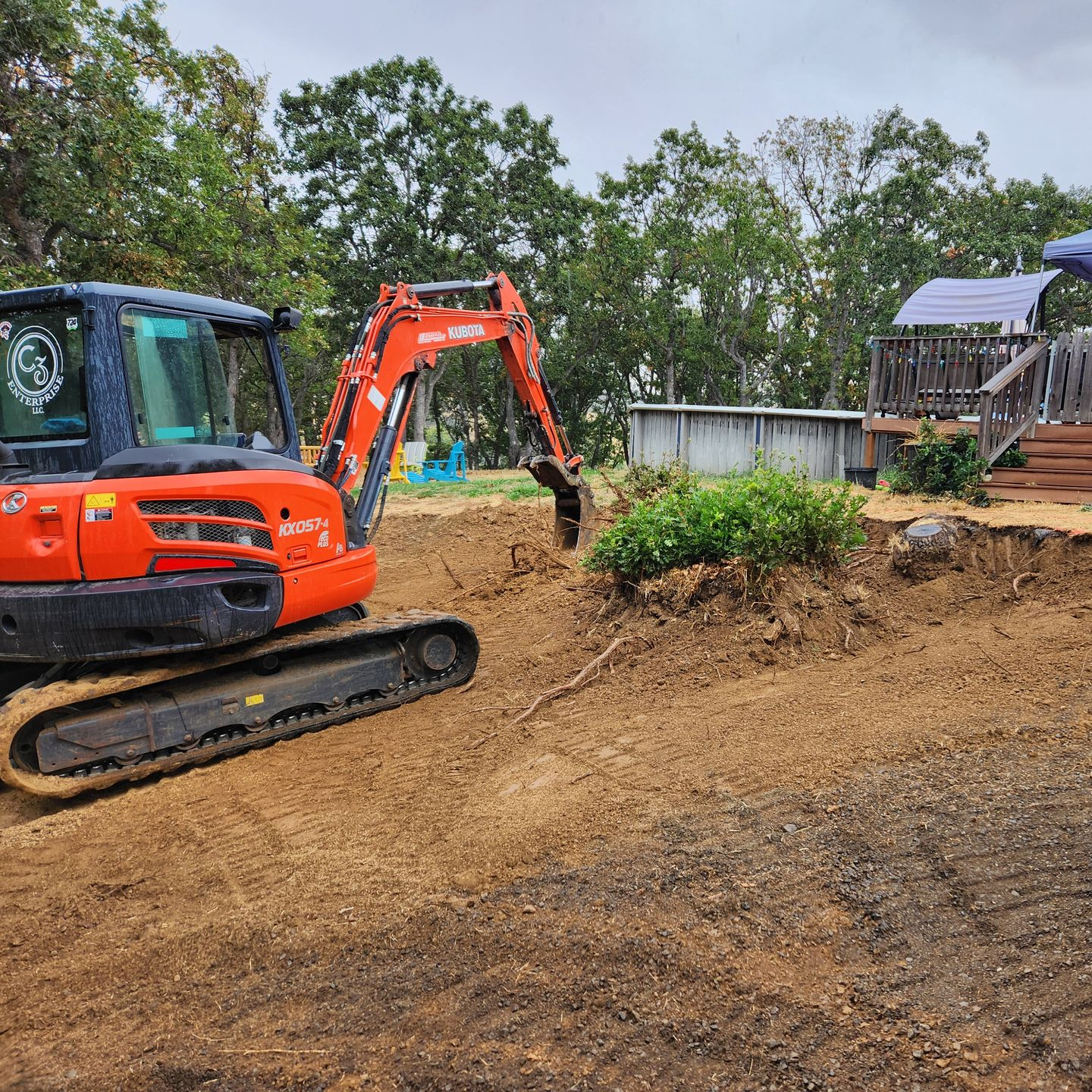 Excavator digging a house pad on a residential site in Medford, Oregon