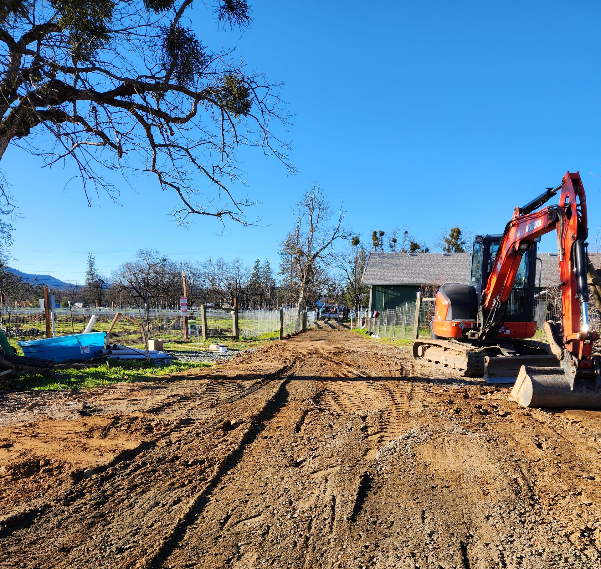 Excavator digging a house pad on a residential site in Ashland, Oregon