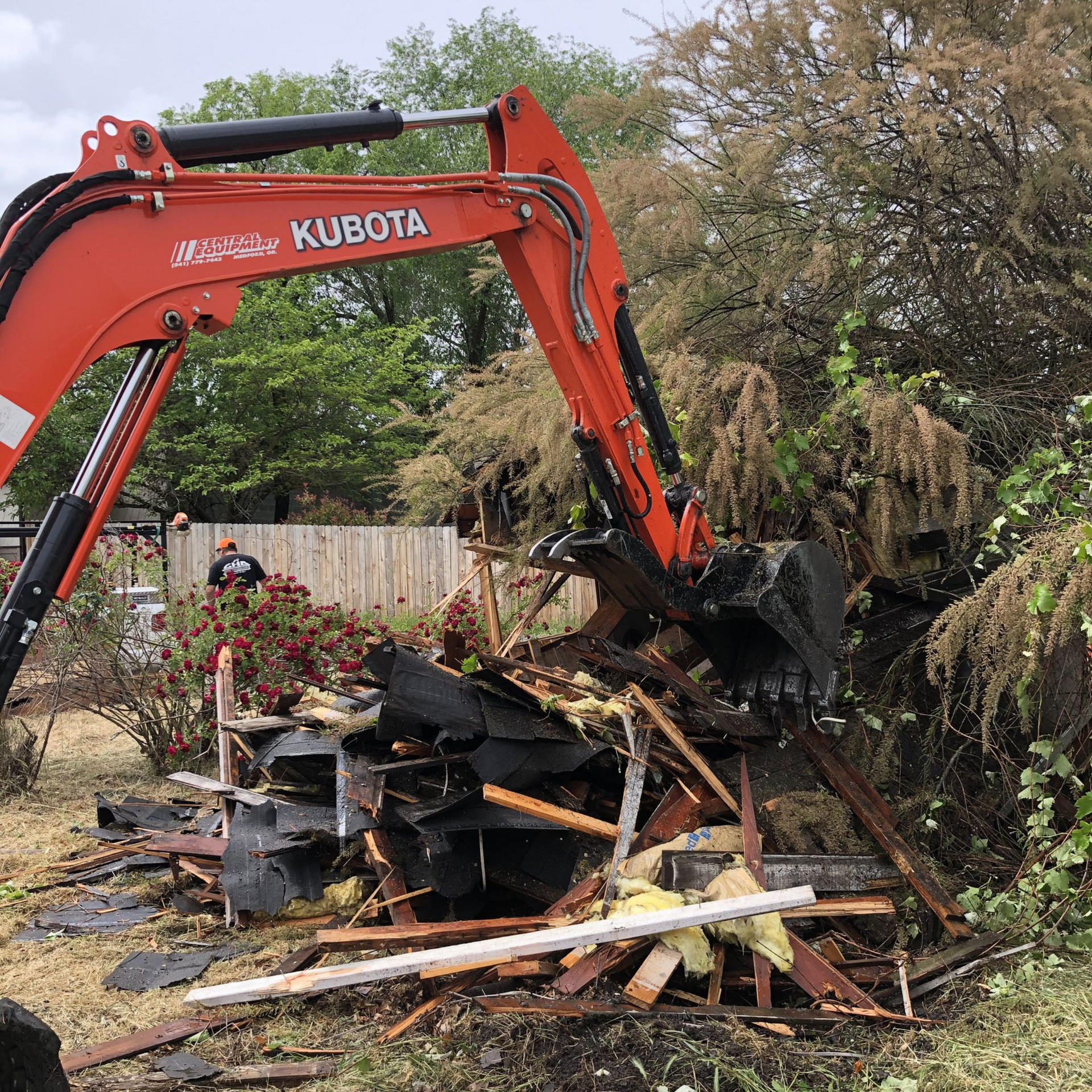 Demolition contractor tearing down a small home in Medford Oregon