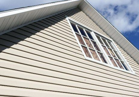 Looking up at the roof of a house with a window