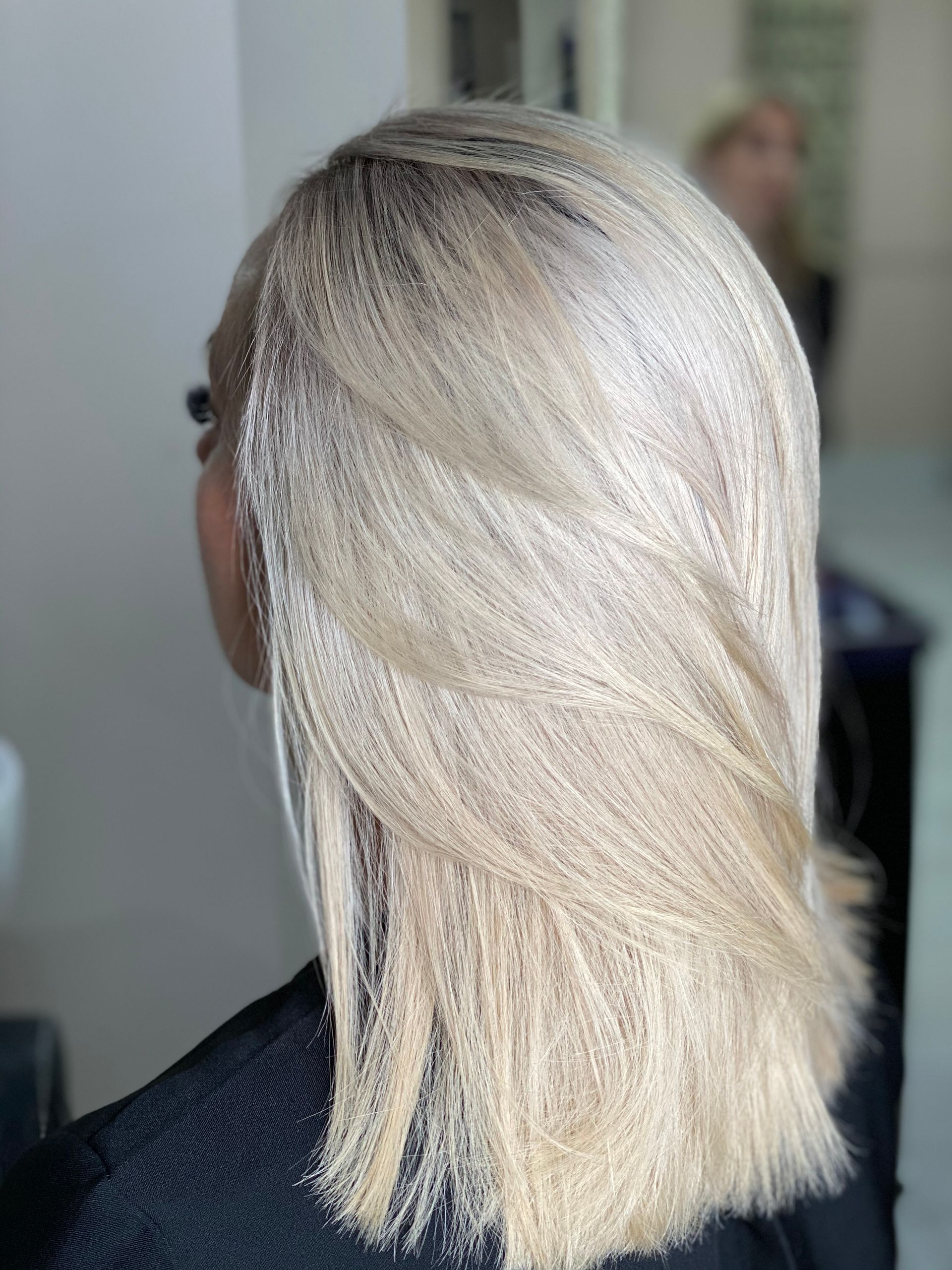 A Woman with Blonde Hair sitting in a seat— Instyle Hair on B in Berserker, QLD