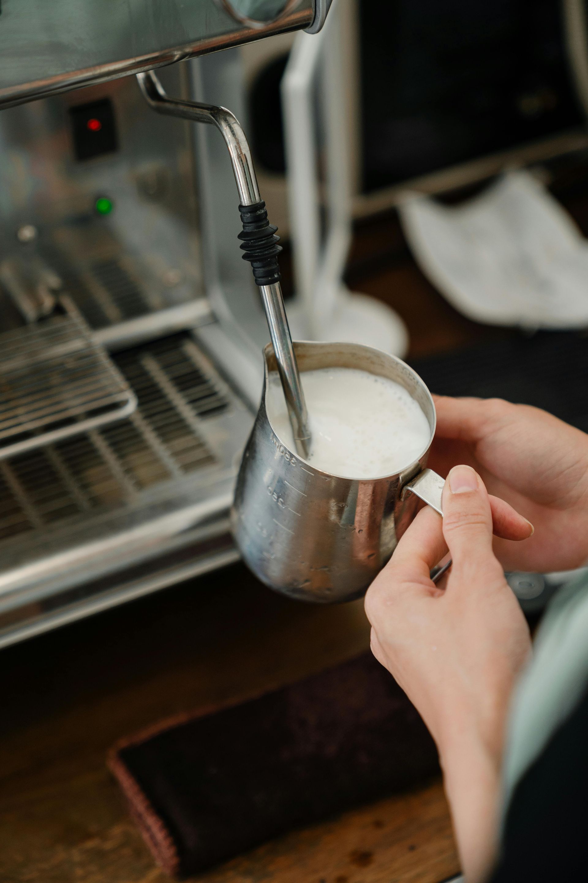 A Barista Frothing Milk  — Scotto's Food Logistics in Mitchell, ACT