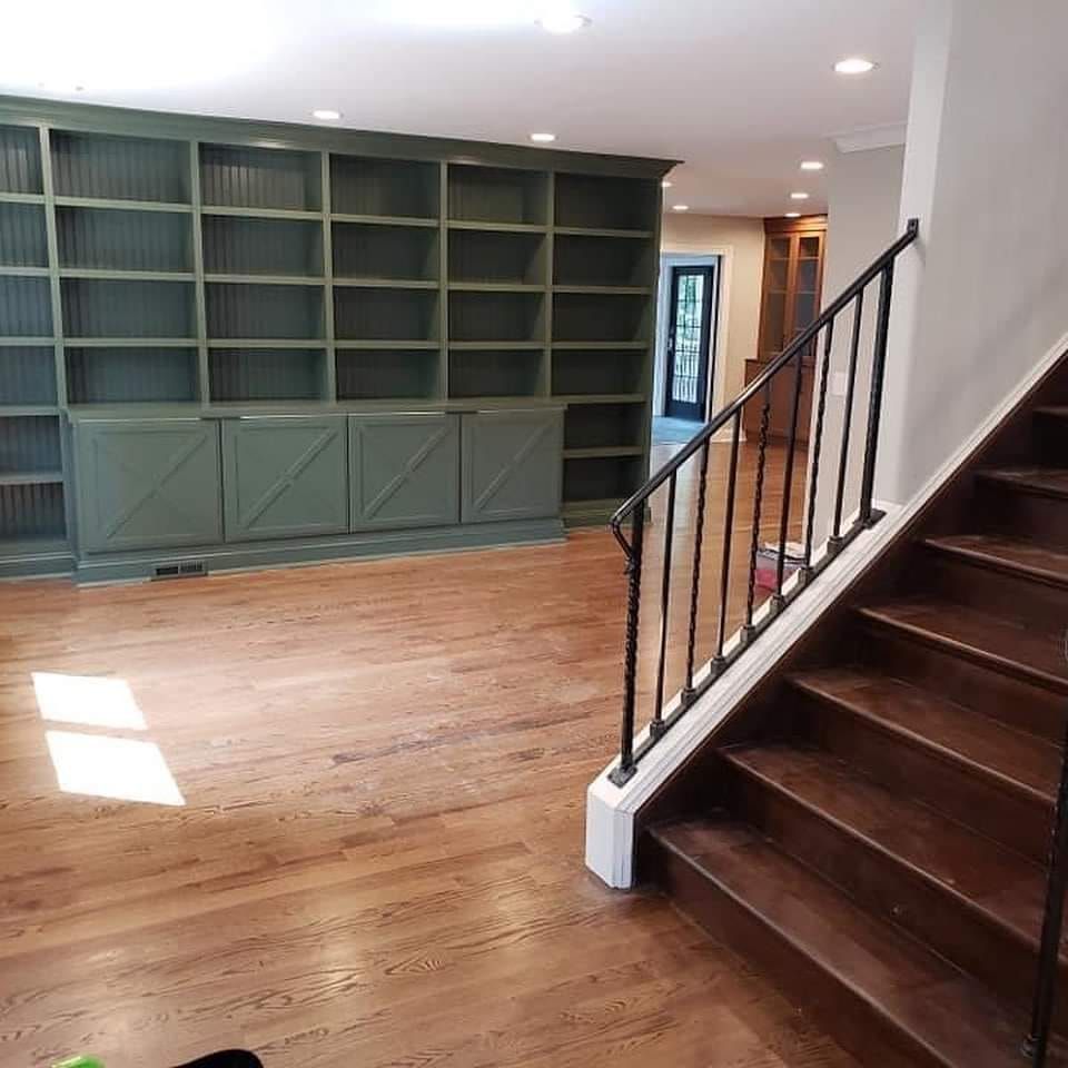 a staircase leading up to a bookshelf in a room