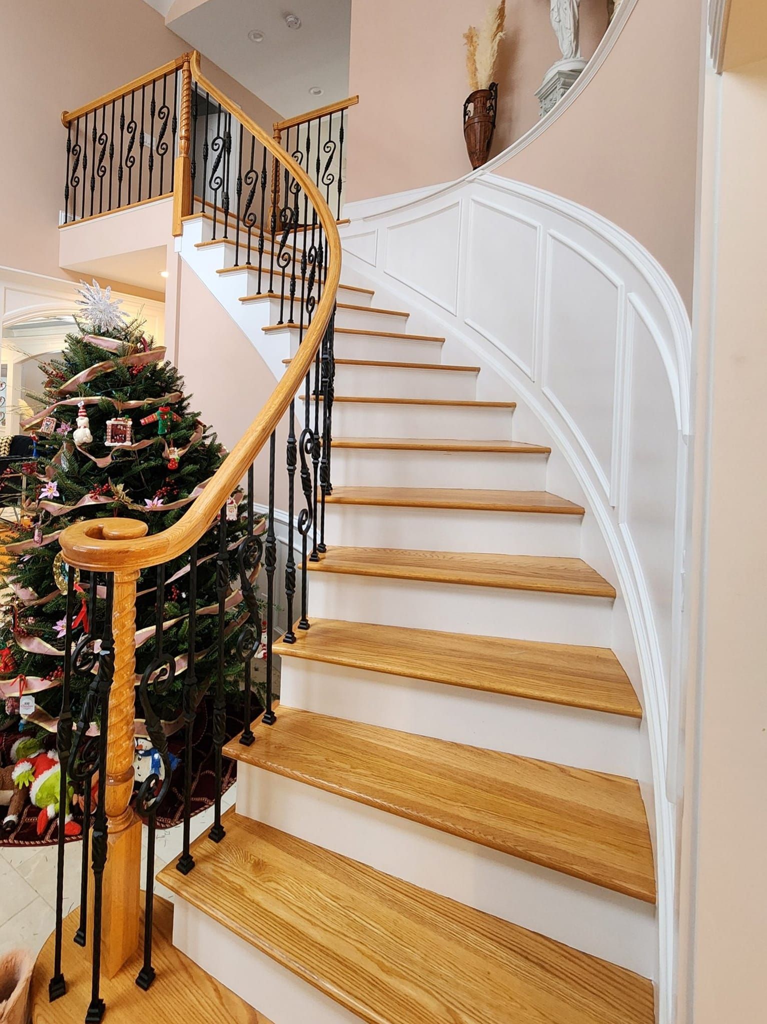 a staircase with a christmas tree in the background
