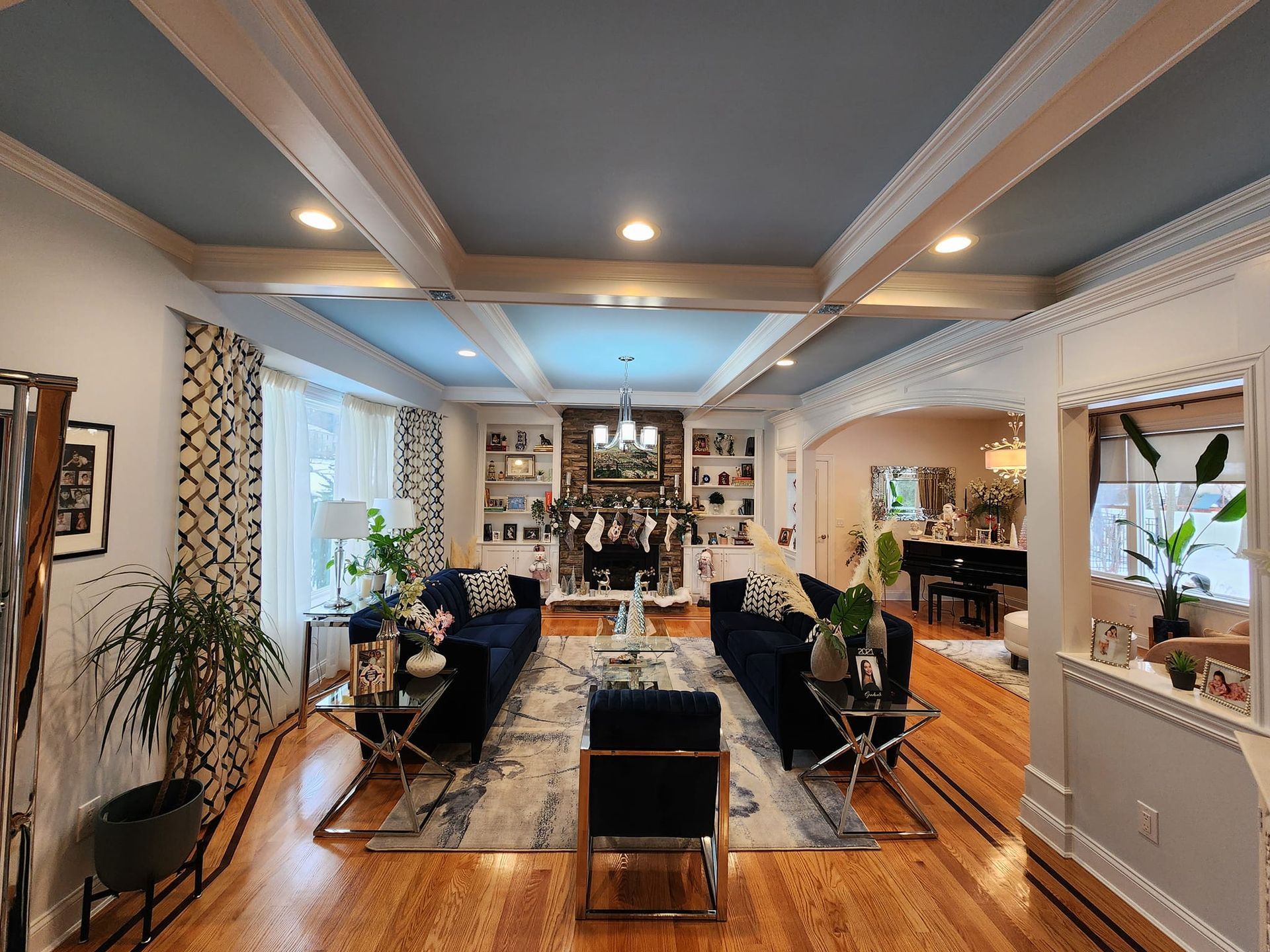 a living room with hardwood floors and a blue ceiling