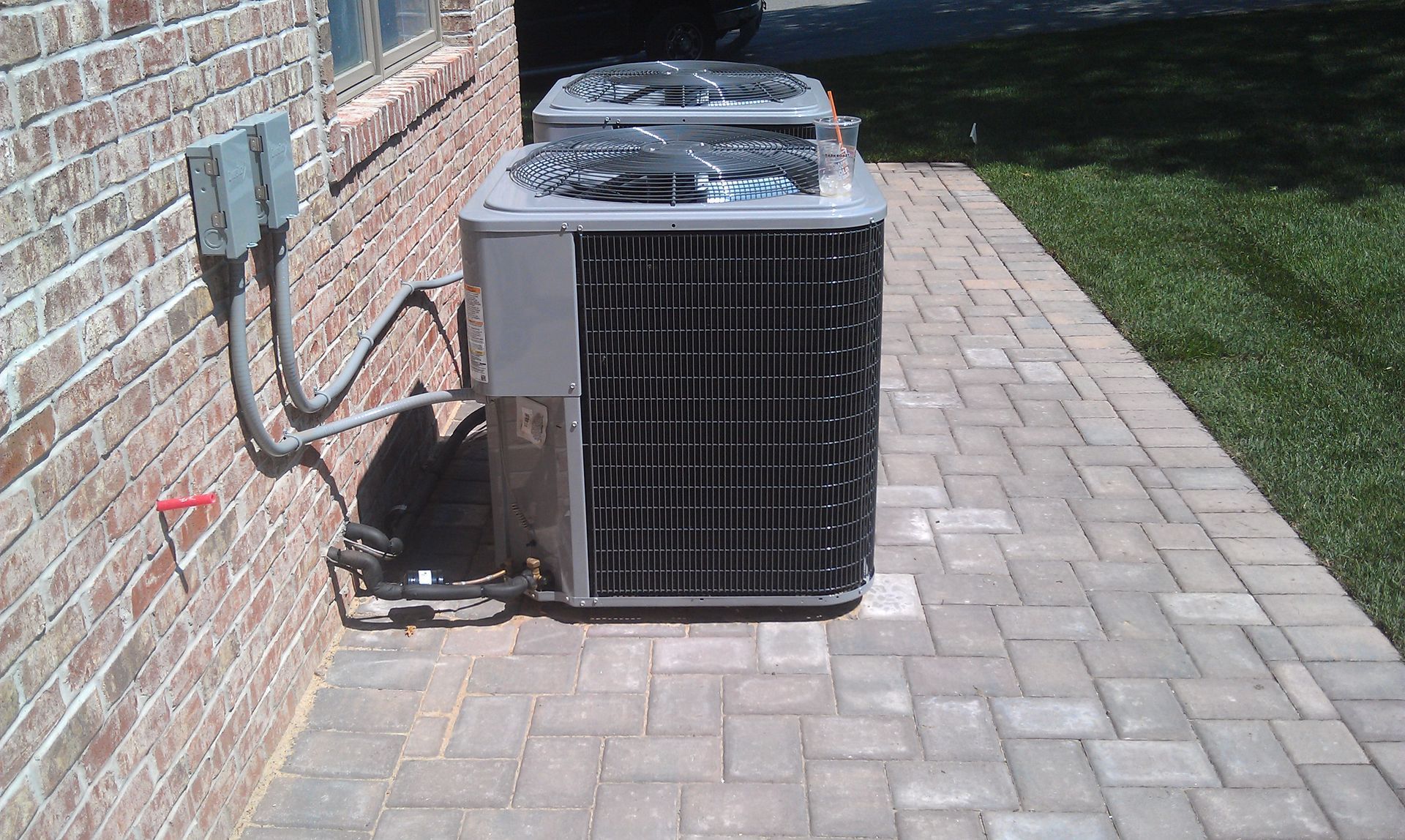a kitchen with white cabinets , marble counter tops , stainless steel appliances and a large island .