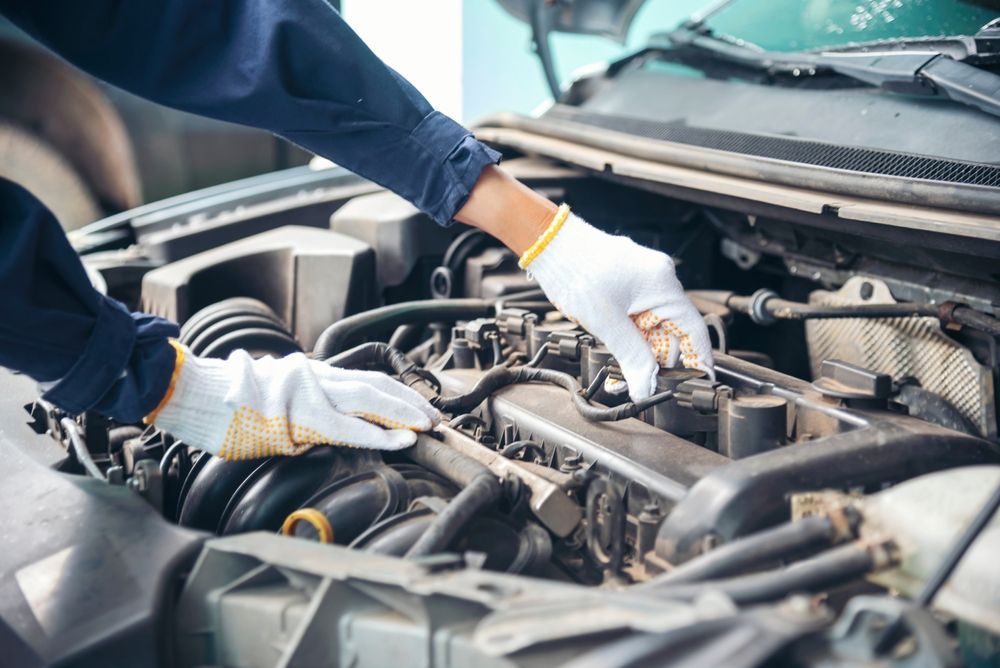 Car Mechanic Working on Car Engine