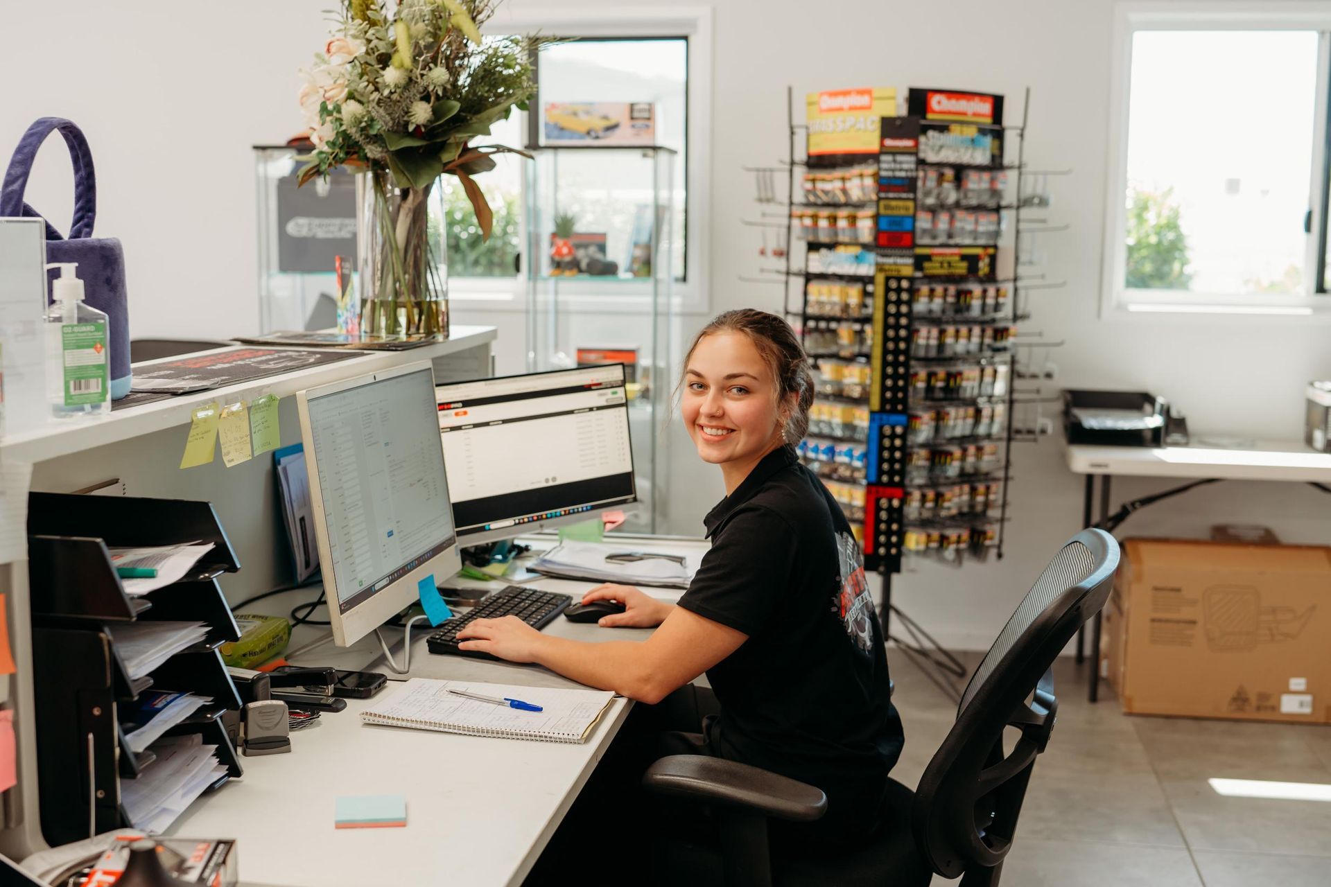 A woman is sitting at a desk in front of a computer — Port City Mechanical In South Gladstone, QLD