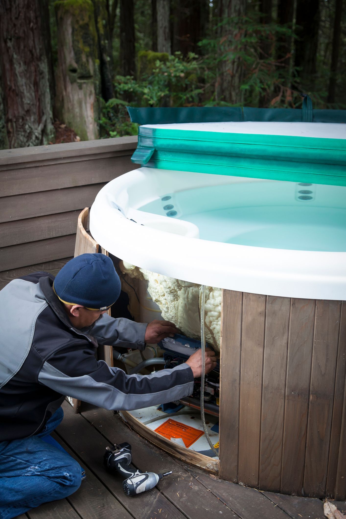 A Man Is Working on A Bottom of Hot Tub - Provo UT - Spa Doctor