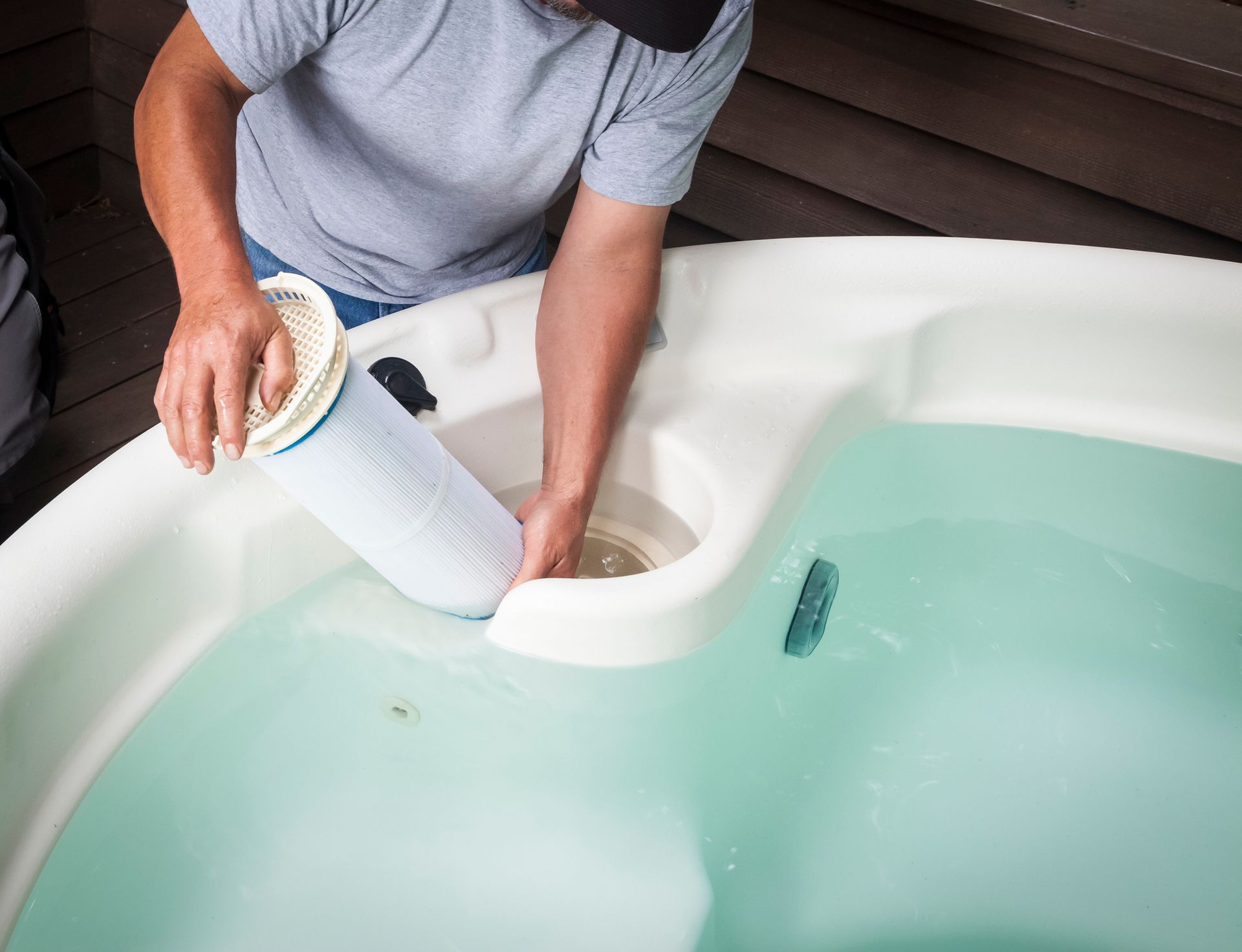 A Man Is Cleaning a Hot Tub with A Filter - Provo UT - Spa Doctor