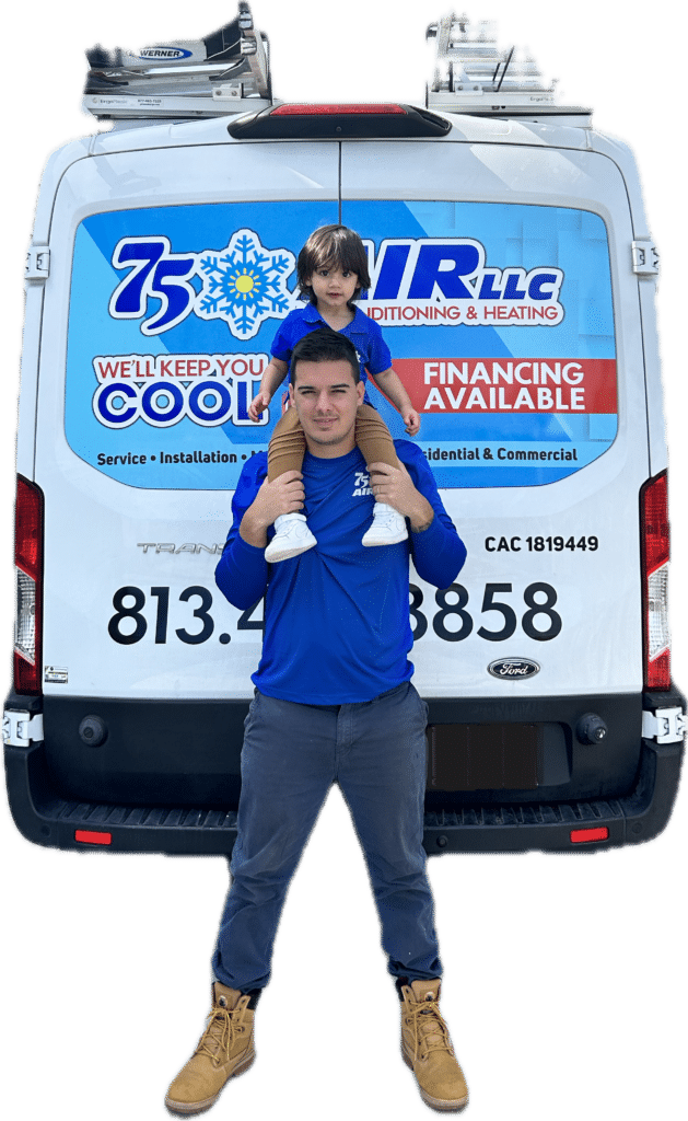 A man is carrying a child on his shoulders in front of a van.