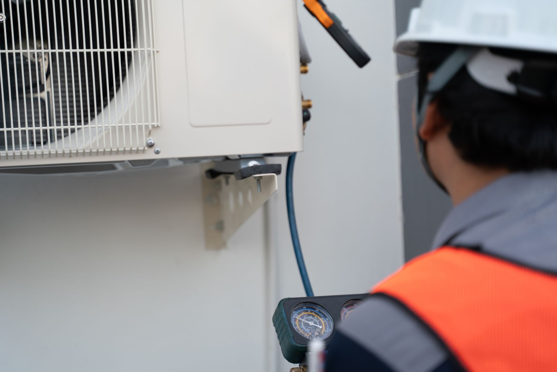 A person in a safety vest and helmet | ac services in Port Richey, FL