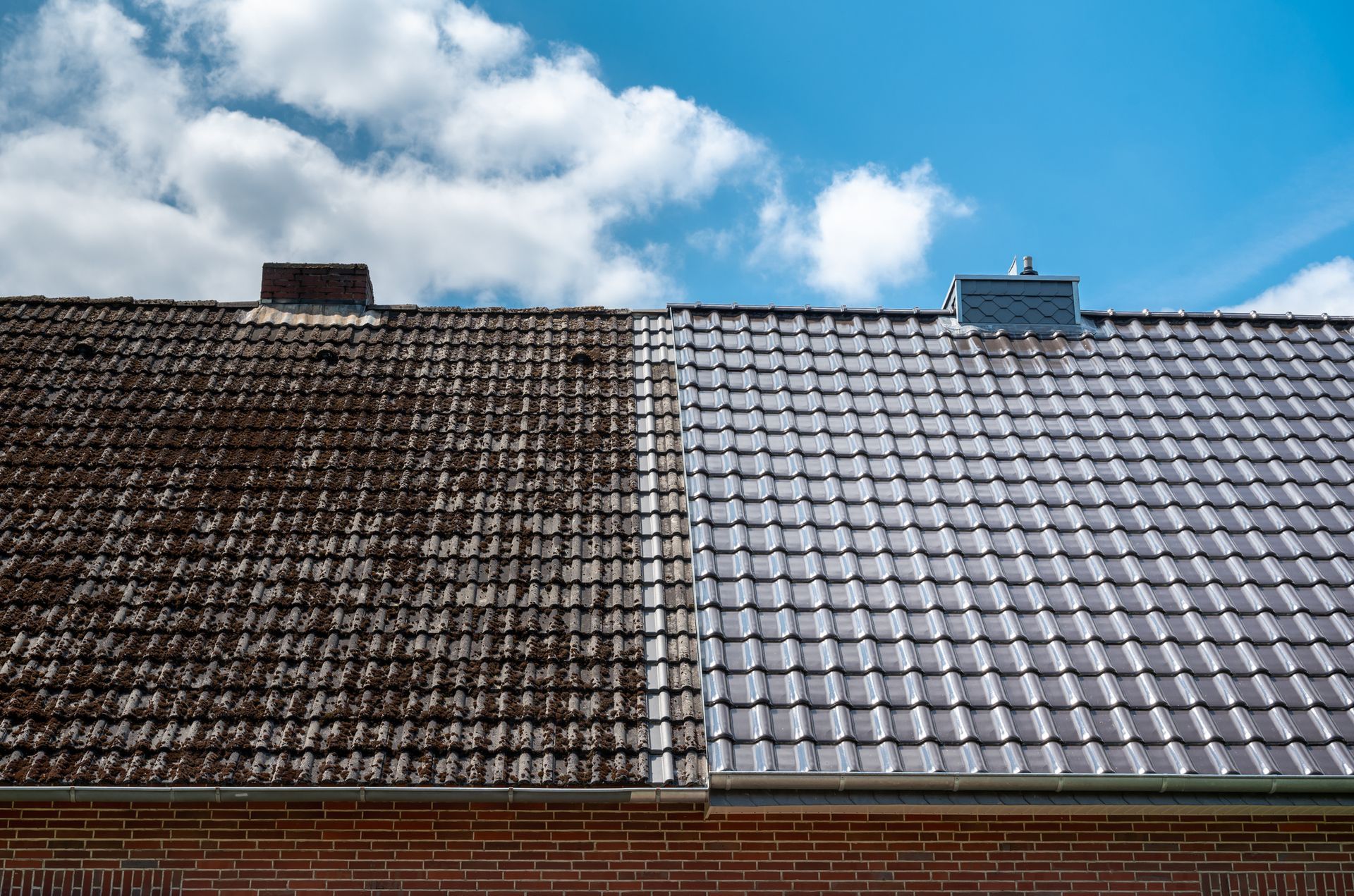 Before and after roof repair—comparison of old tiles and newly installed clean roofing tiles.