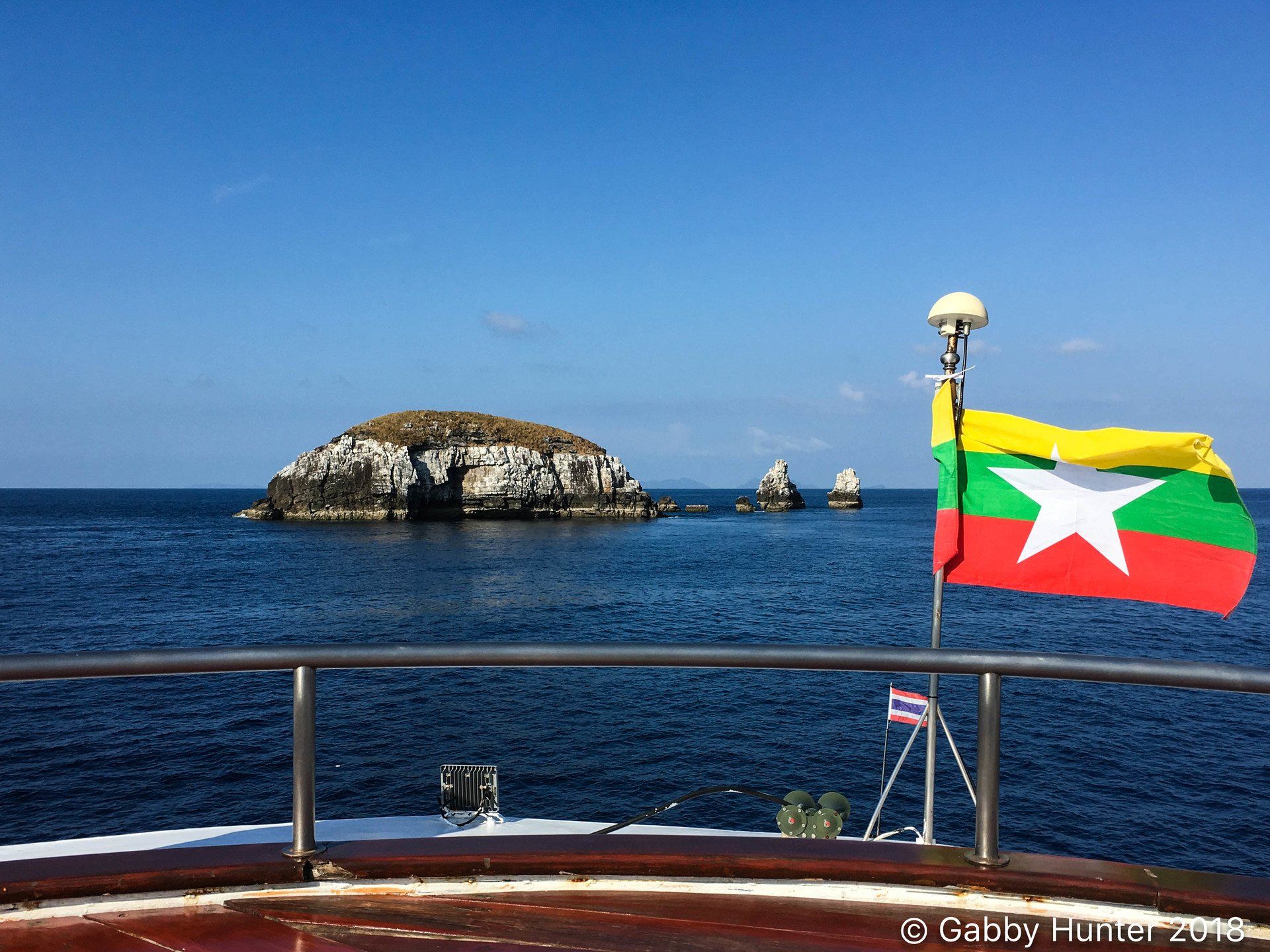 Myanmar flag on a boat looking toward the ocean