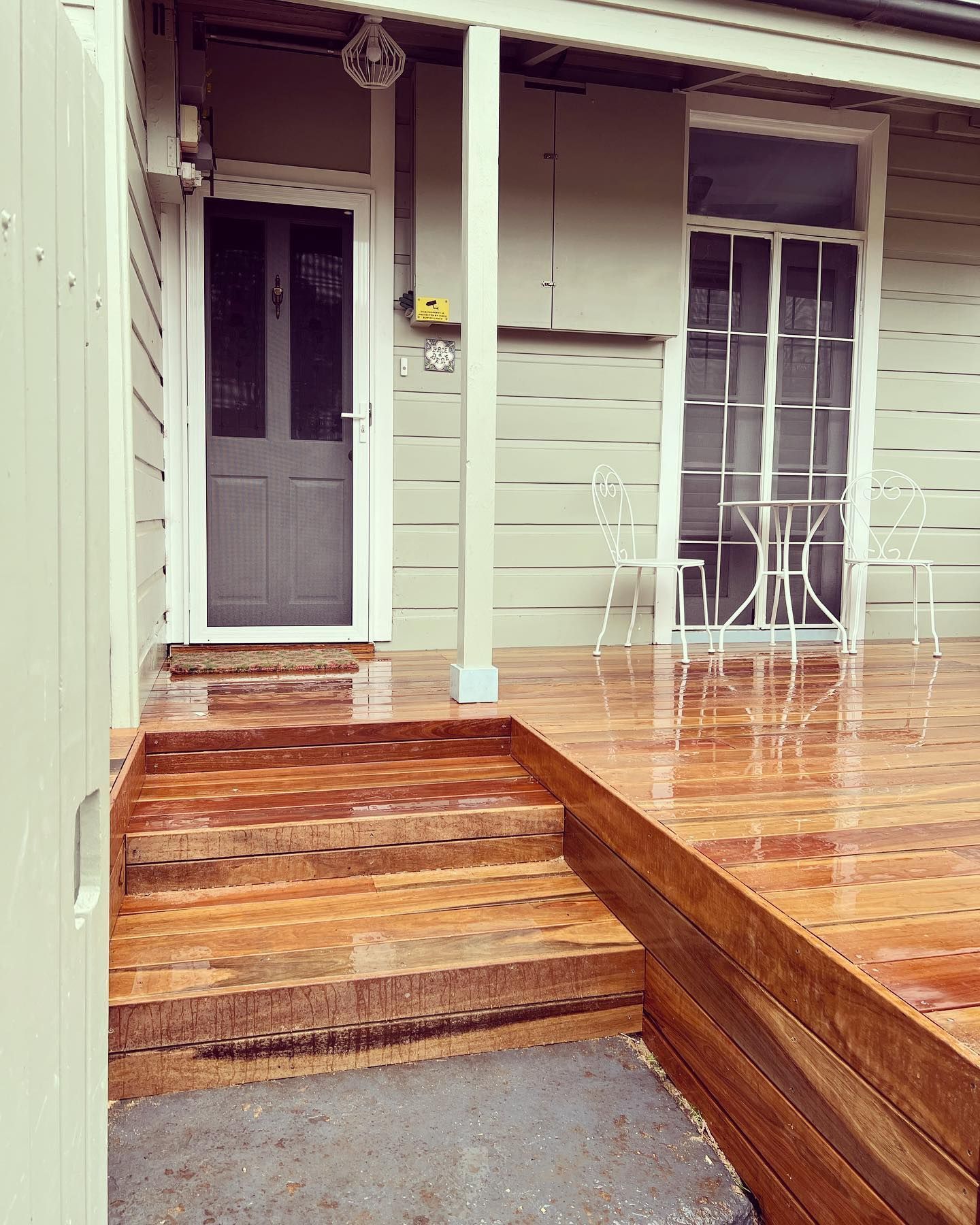 Wooden Porch With Steps Leading to a Front Door and a Window — J&C Quality Construction in Goulburn, NSW