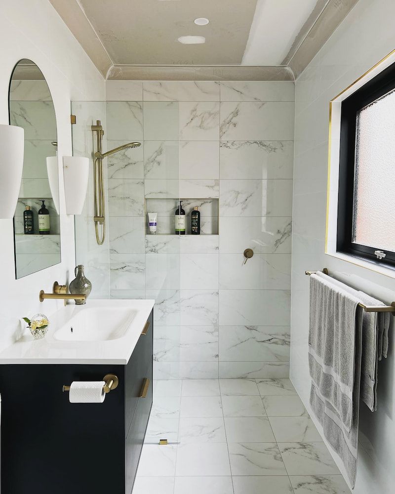 A Bathroom With A Sink A Mirror And A Window — J&C Quality Construction in Goulburn, NSW