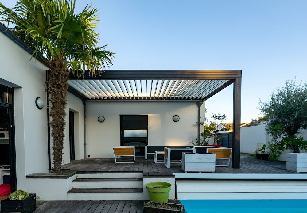 Outdoor Patio With Pergola, Pool, and Palm Tree — J&C Quality Construction in Canberra, ACT