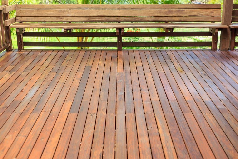 A Wooden Deck With A Wooden Bench On It — J&C Quality Construction in Goulburn, NSW