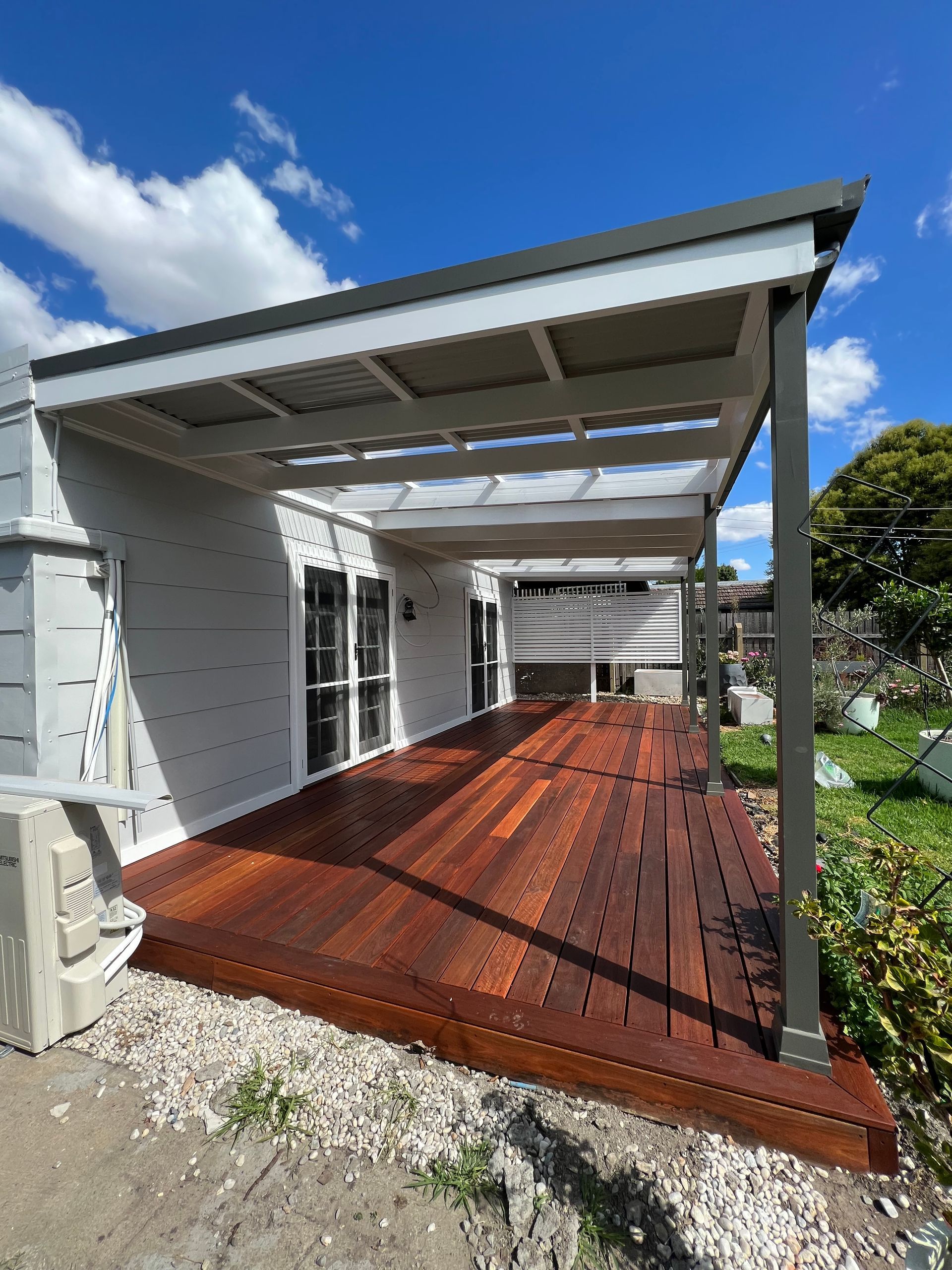 A Wooden Deck With A Bench On It And Trees — J&C Quality Construction in Goulburn, NSW