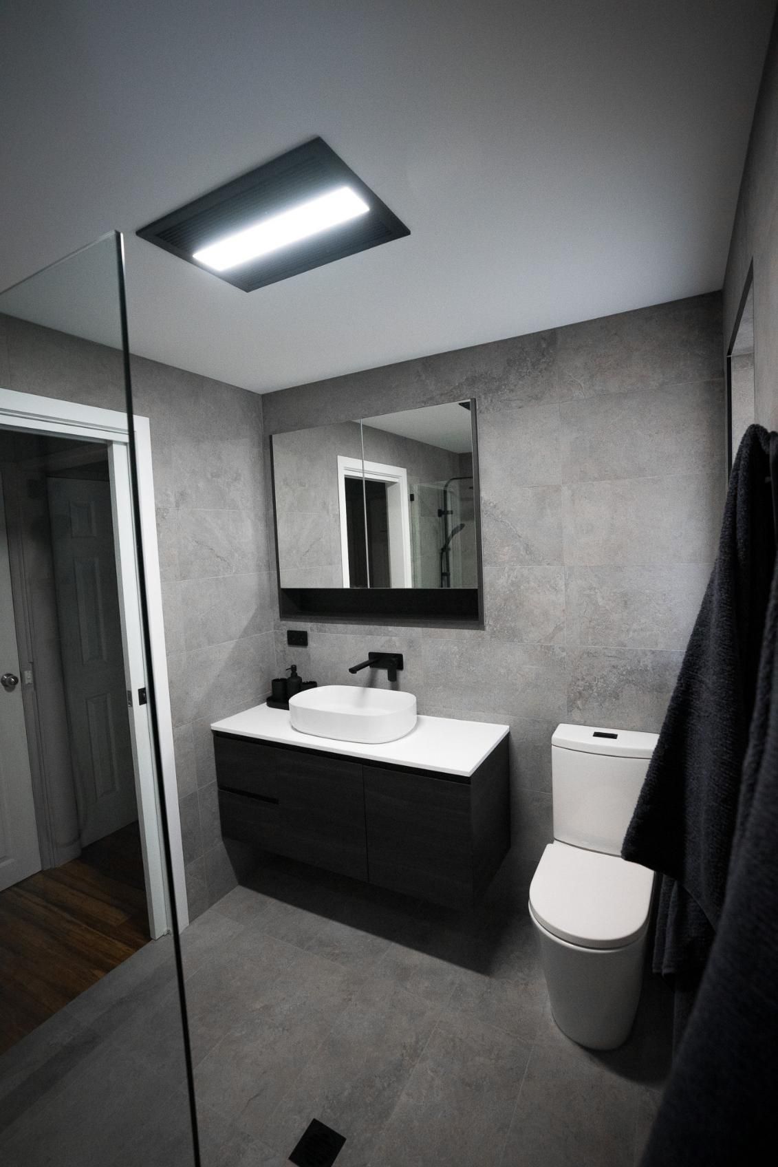 Modern Bathroom With Grey Tile Walls — J&C Quality Construction in Goulburn, NSW