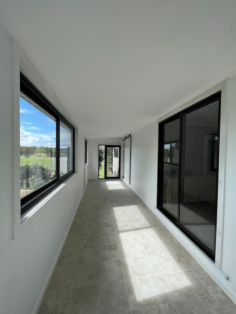 Long Hallway With Windows and Sliding Glass Door — J&C Quality Construction in Goulburn, NSW