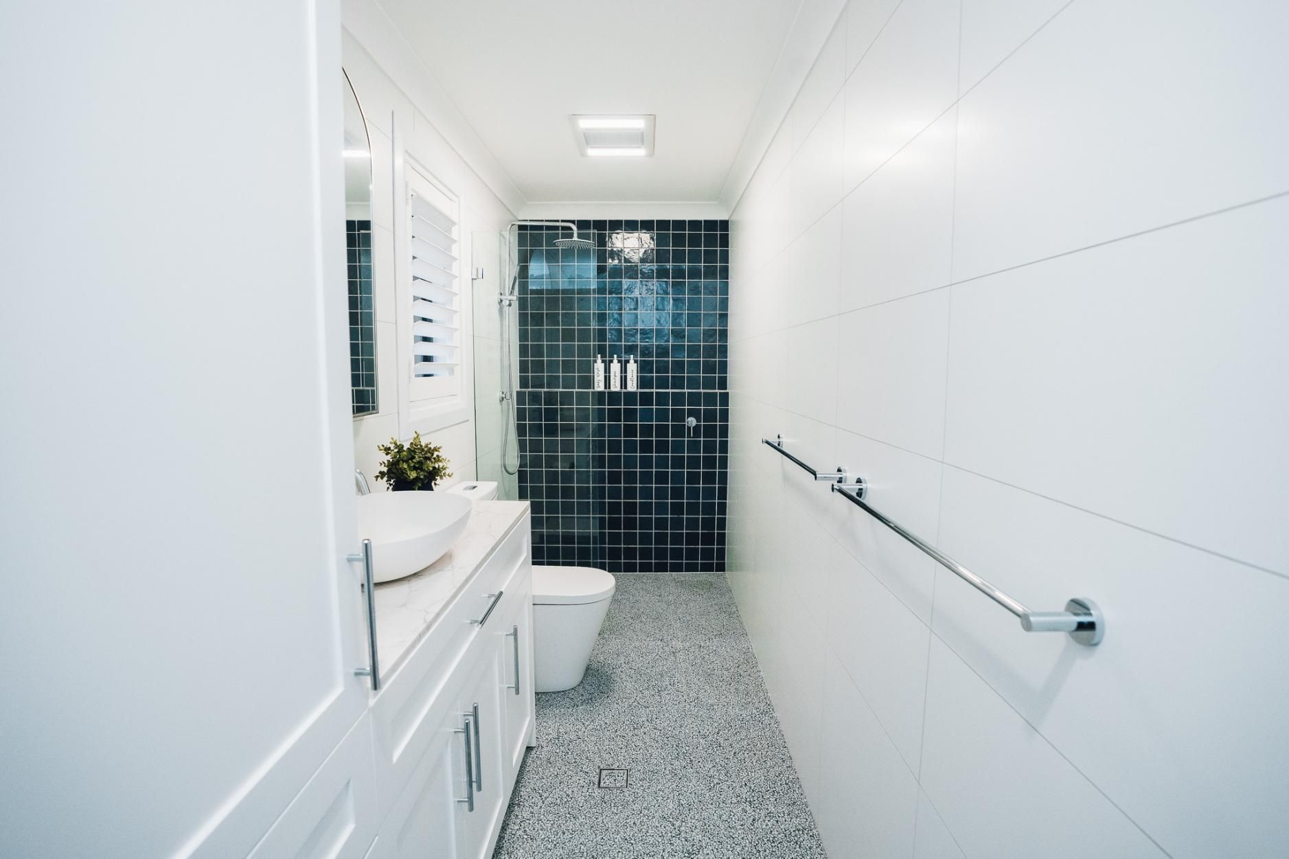 Narrow, Modern Bathroom With White Tile Walls — J&C Quality Construction in Goulburn, NSW