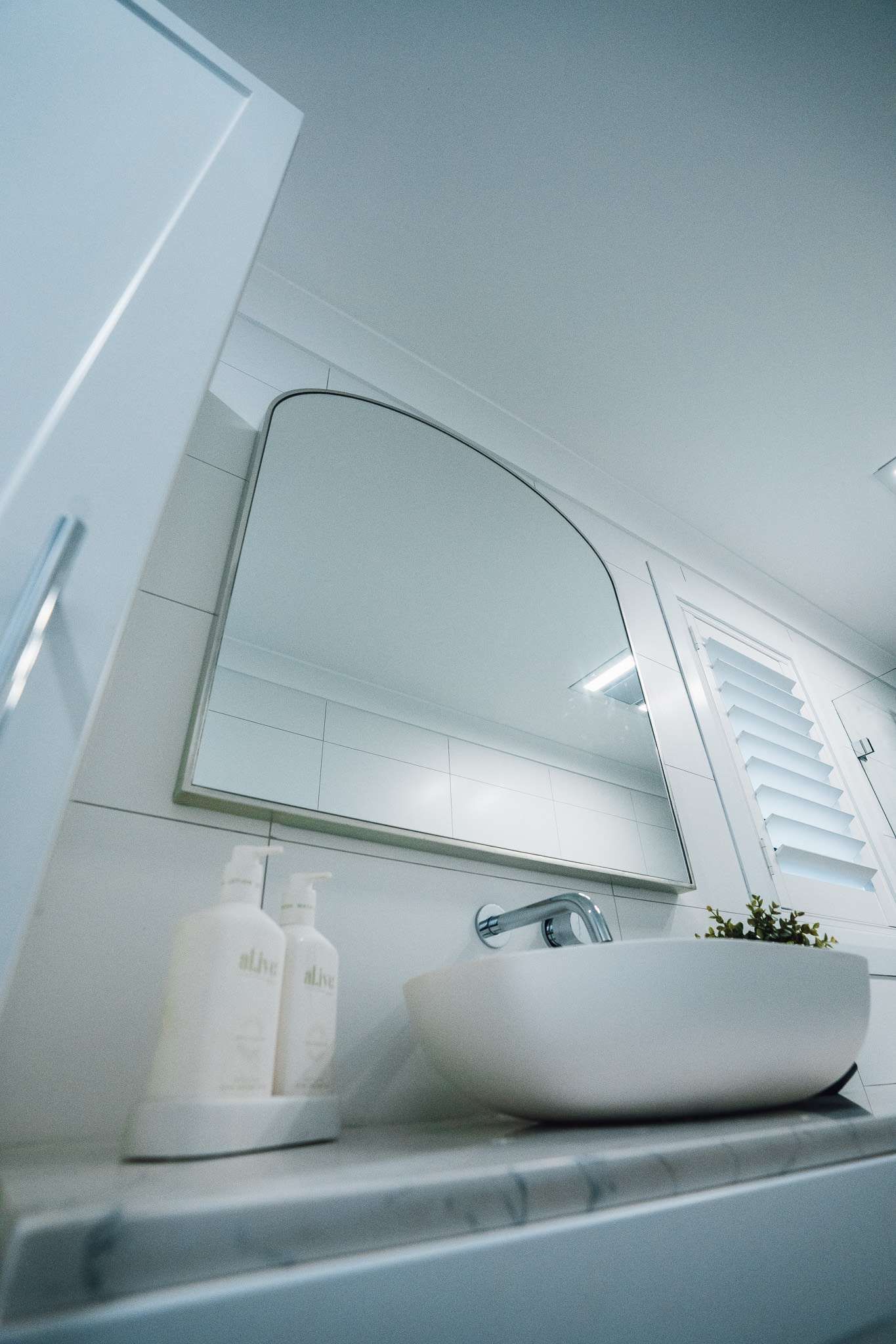 A Bathroom With A Sink And A Mirror On The Wall — J&C Quality Construction in Goulburn, NSW