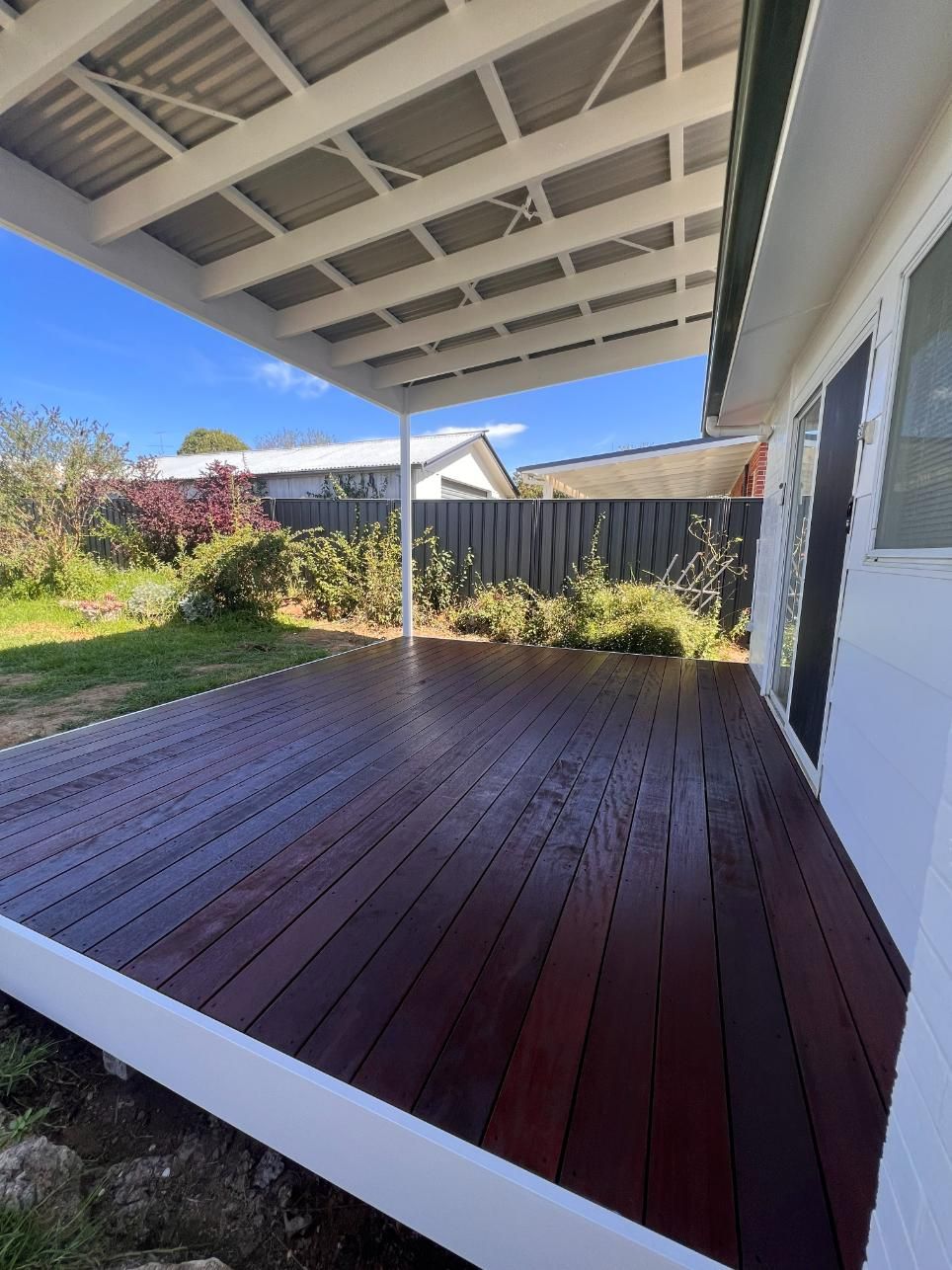 Wooden Deck With a White-framed Corrugated Metal Roof — J&C Quality Construction in Goulburn, NSW