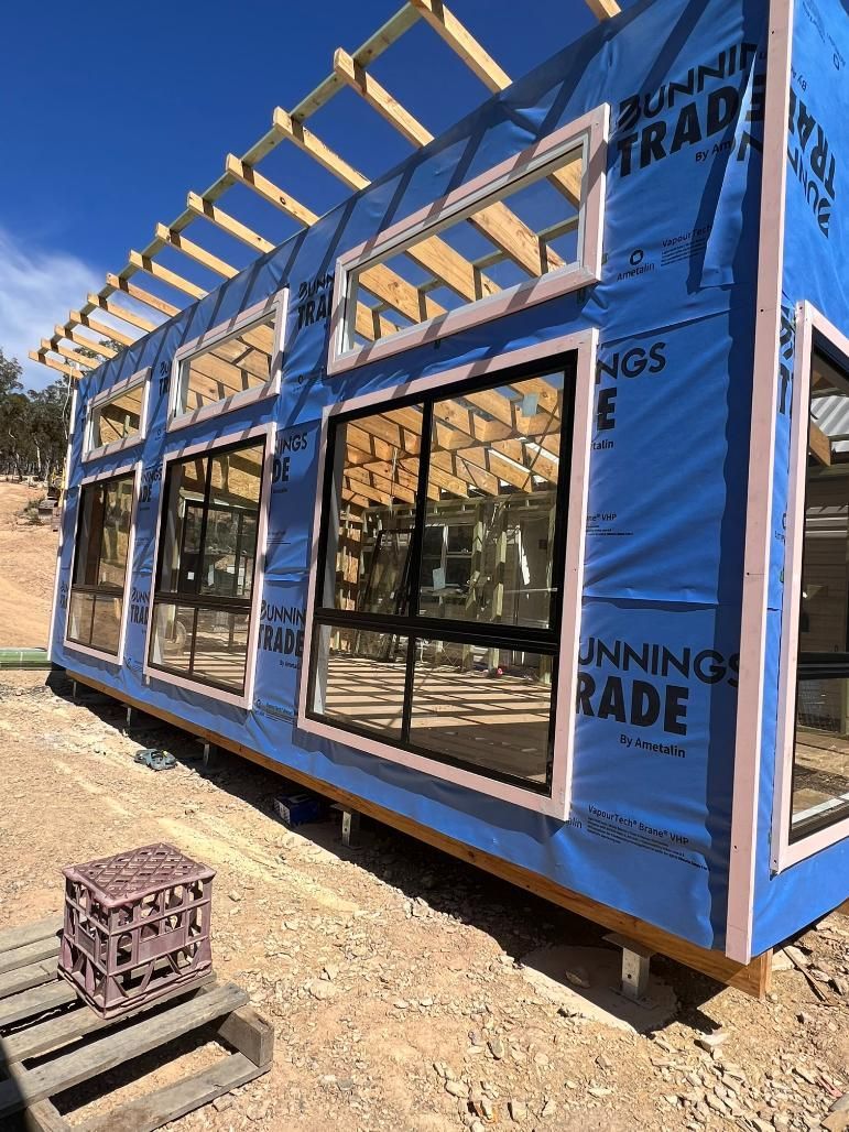 Building Exterior Under Construction With Blue Protective — J&C Quality Construction in Goulburn, NSW