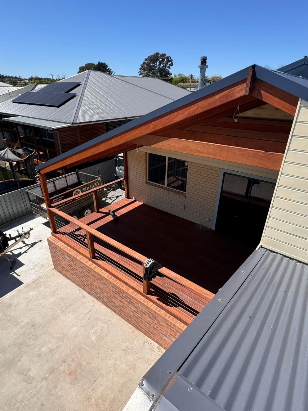 A Wooden Deck With a Brick Base and Roof Extension — J&C Quality Construction in Goulburn, NSW