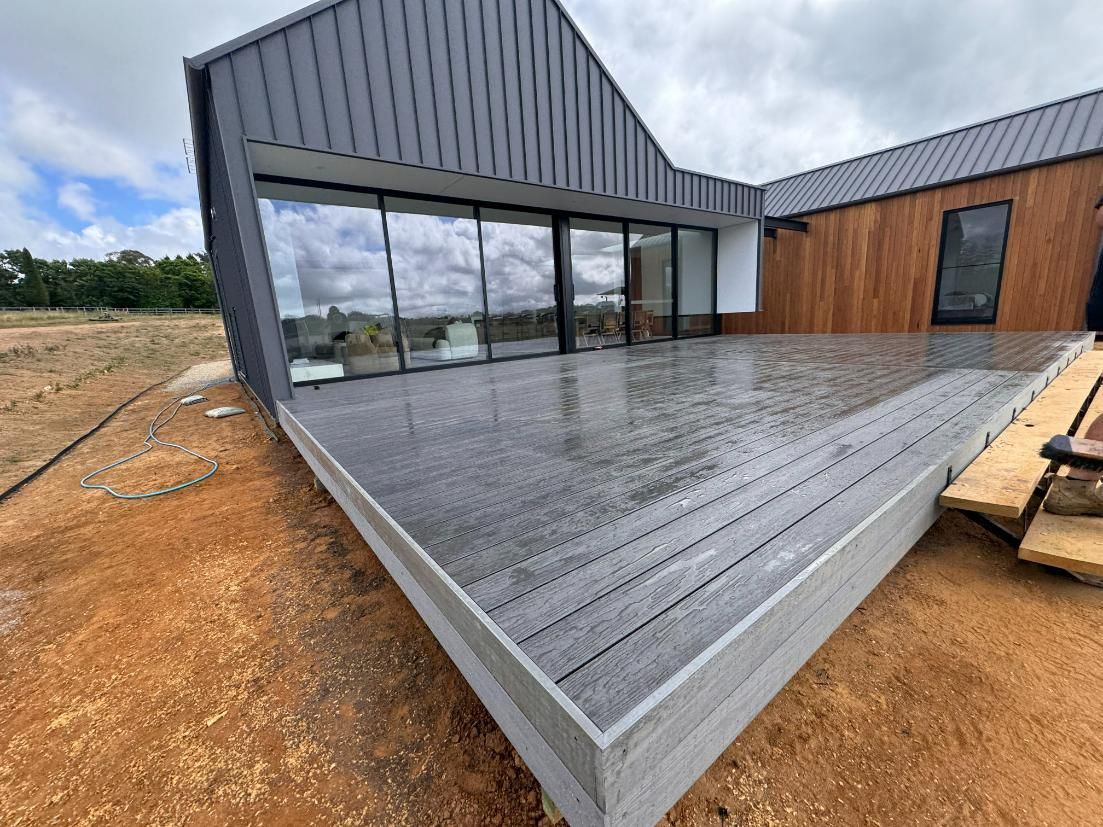 Modern House Exterior With Grey Deck, Large Glass Doors — J&C Quality Construction in Goulburn, NSW