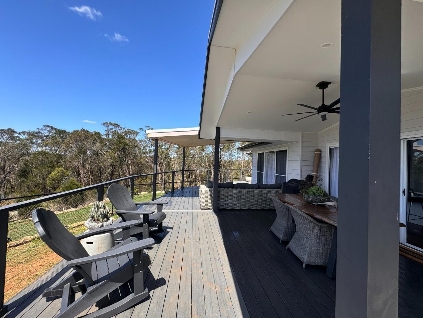 Deck With Dark Chairs Overlooking a Forest — J&C Quality Construction in Goulburn, NSW