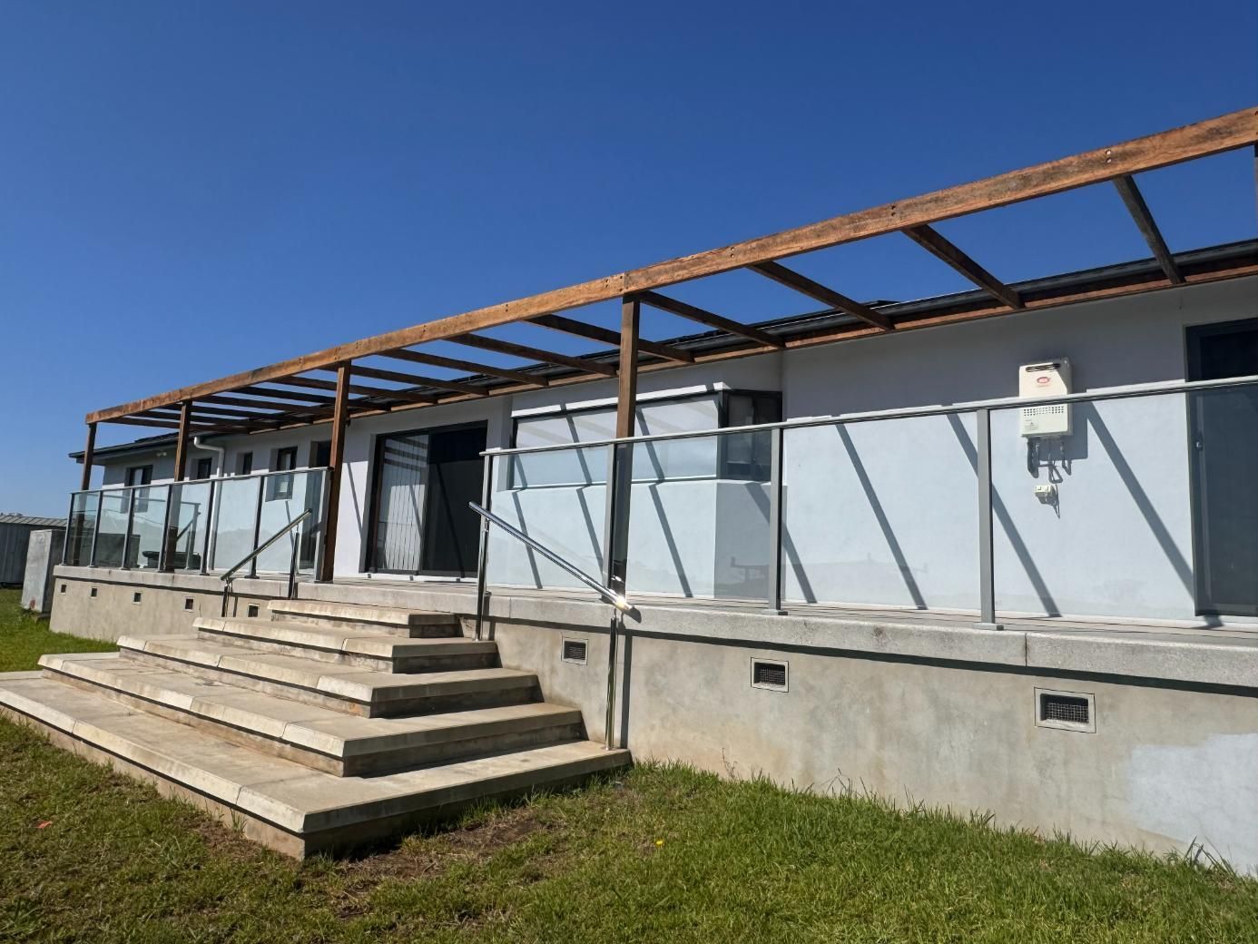White Building With Glass Railing — J&C Quality Construction in Goulburn, NSW