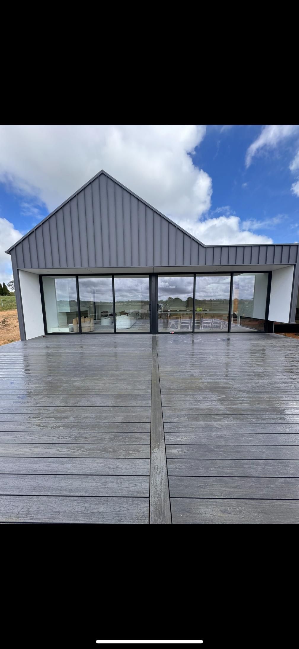 Modern House With Glass Windows, Grey Roof — J&C Quality Construction in Goulburn, NSW