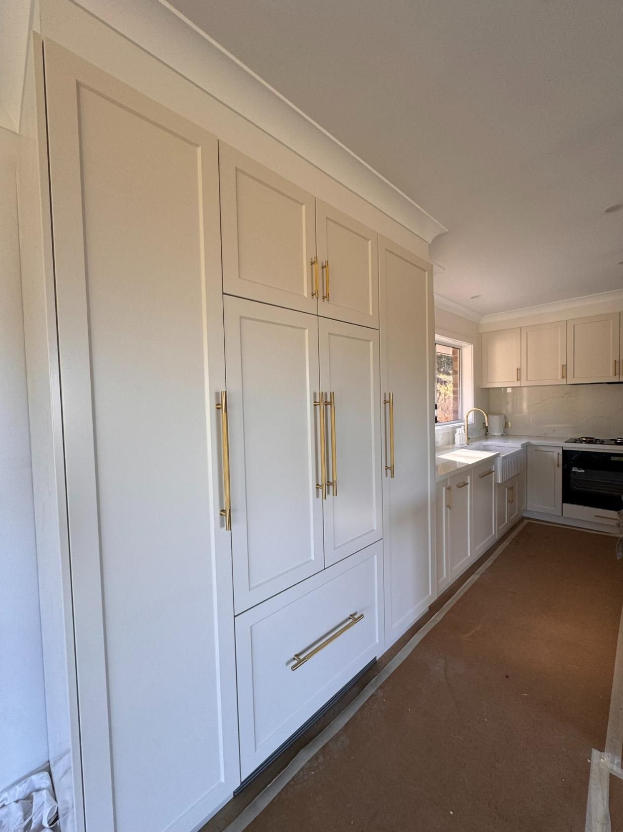 Cream-coloured Built-in Kitchen Cabinets With Gold Hardware — J&C Quality Construction in Goulburn, NSW