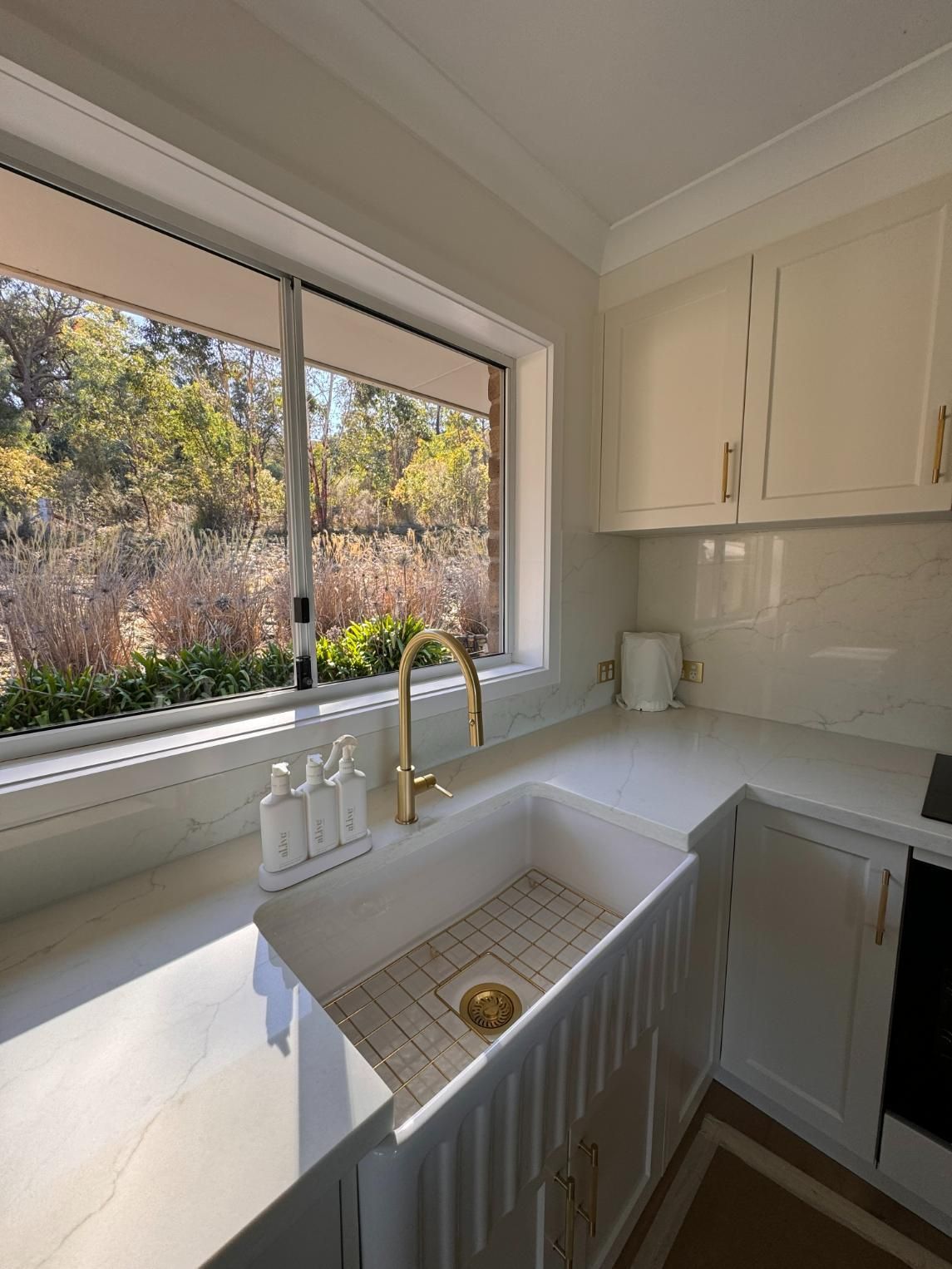 White Kitchen With Gold Faucet — J&C Quality Construction in Goulburn, NSW