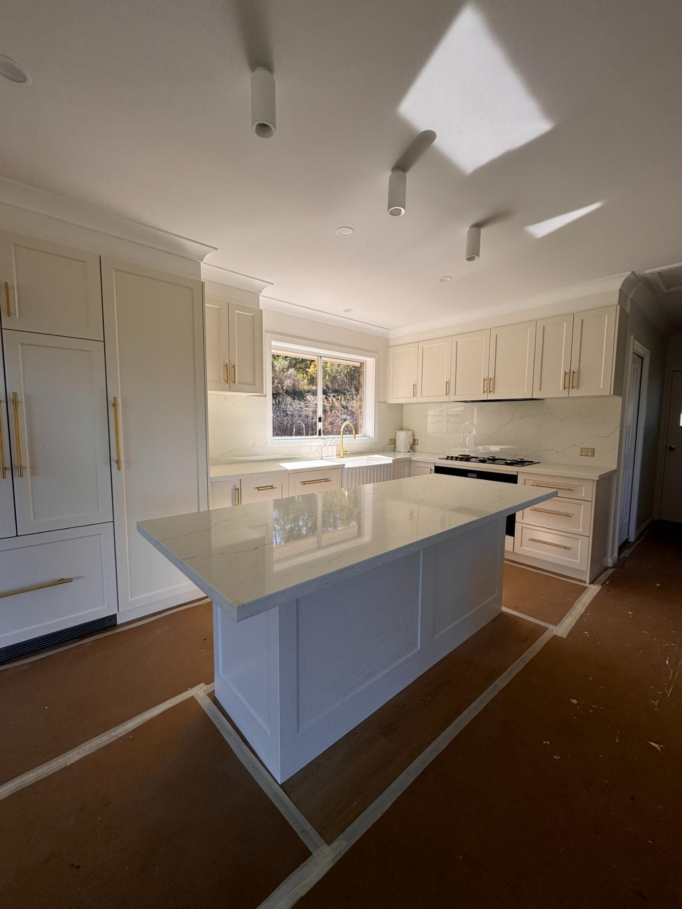 White Kitchen With a Large Island — J&C Quality Construction in Goulburn, NSW