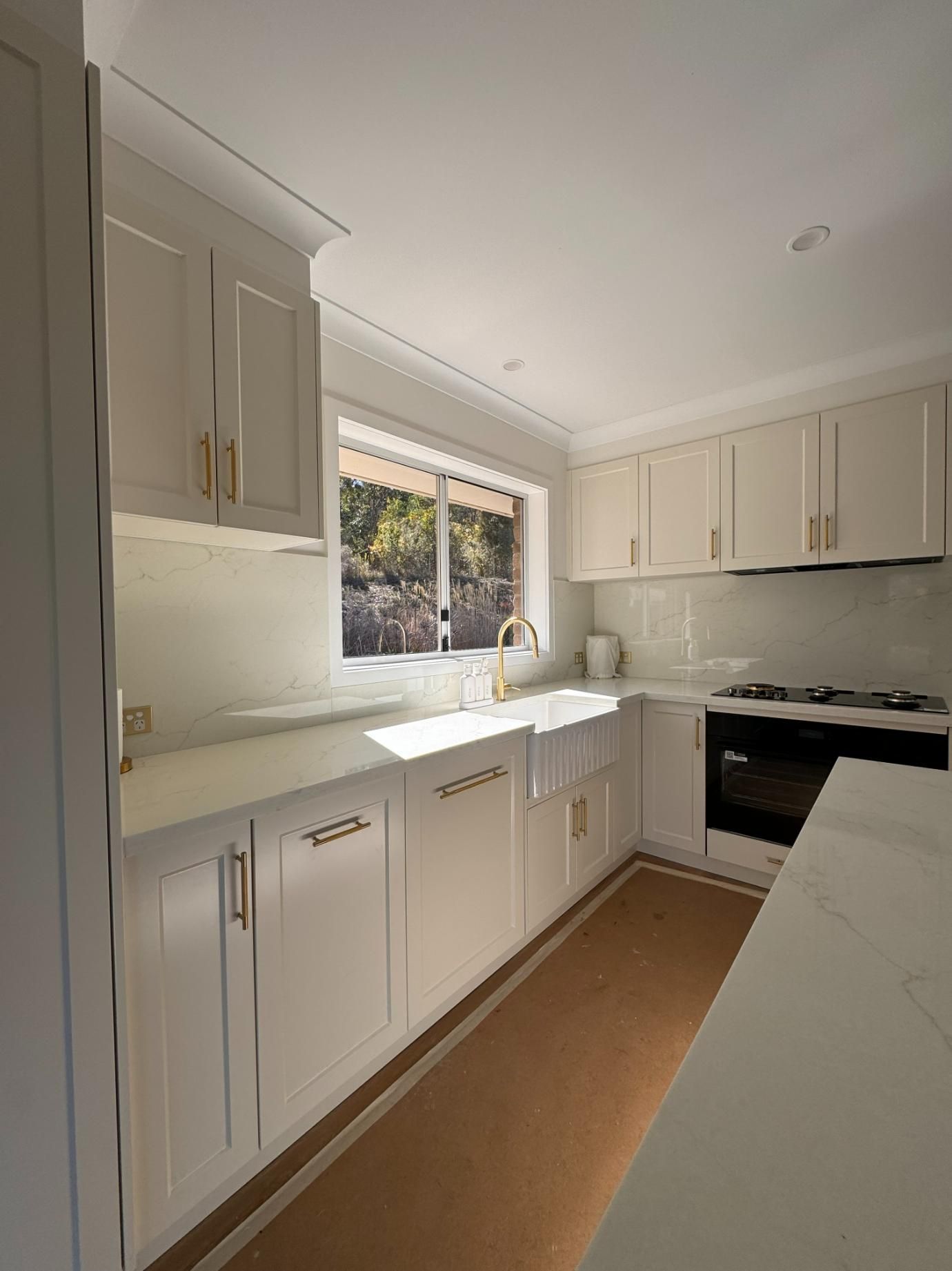 White Kitchen With Cabinets, Window, and Sink. Sunny, Bright — J&C Quality Construction in Canberra, ACT