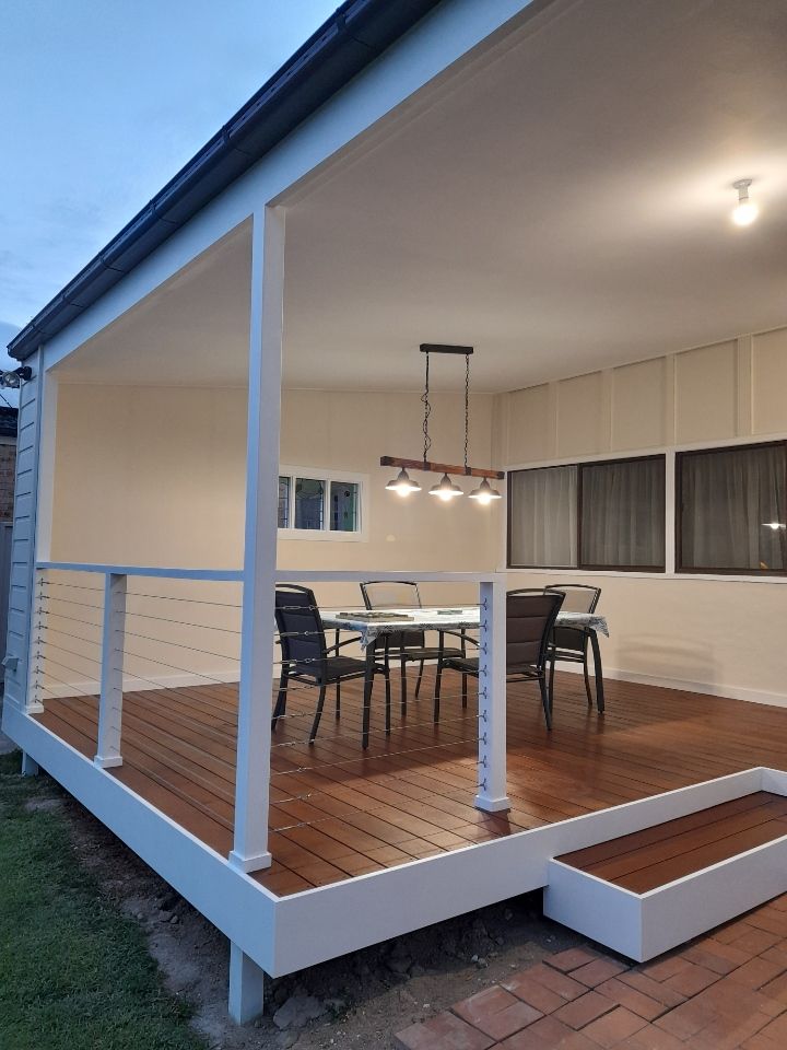 A wooden deck with a table and chairs on it — JWM Allround Carpentry Construction in Goulburn, NSW