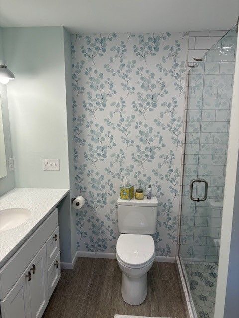 A bathroom with a toilet , sink , and shower.