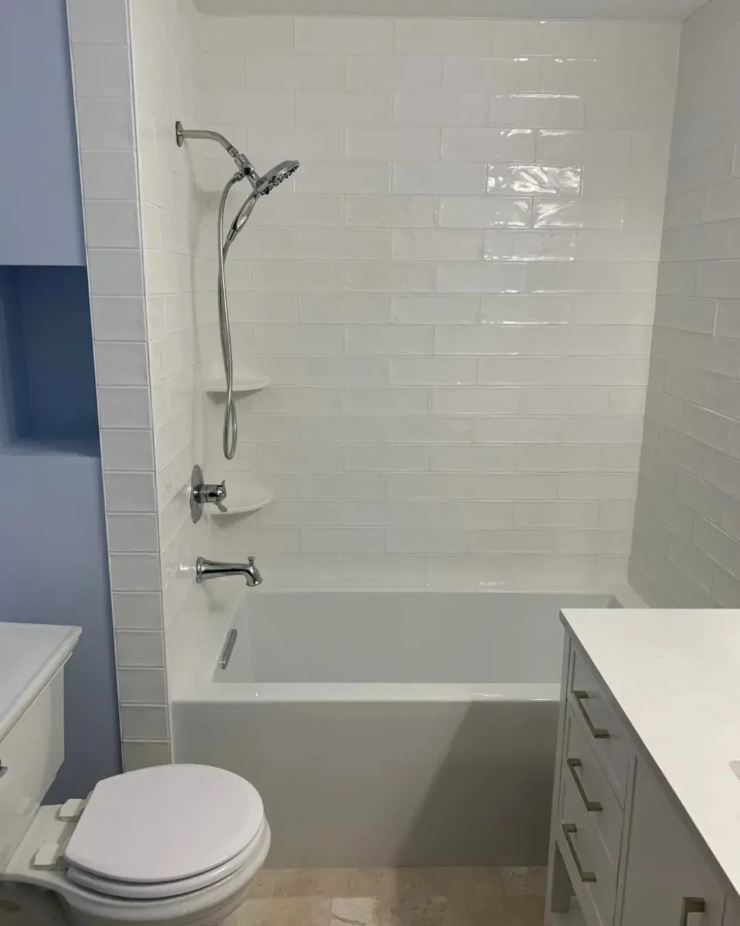 A bathroom with a toilet , bathtub and shower.