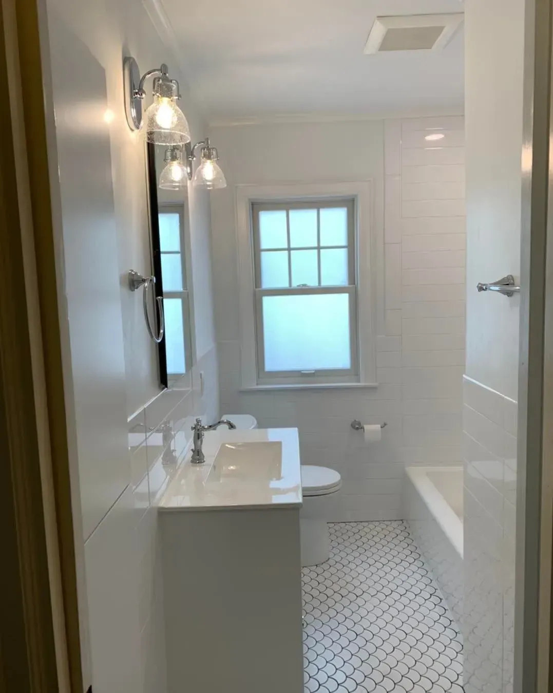 A bathroom with a sink , toilet , and bathtub.