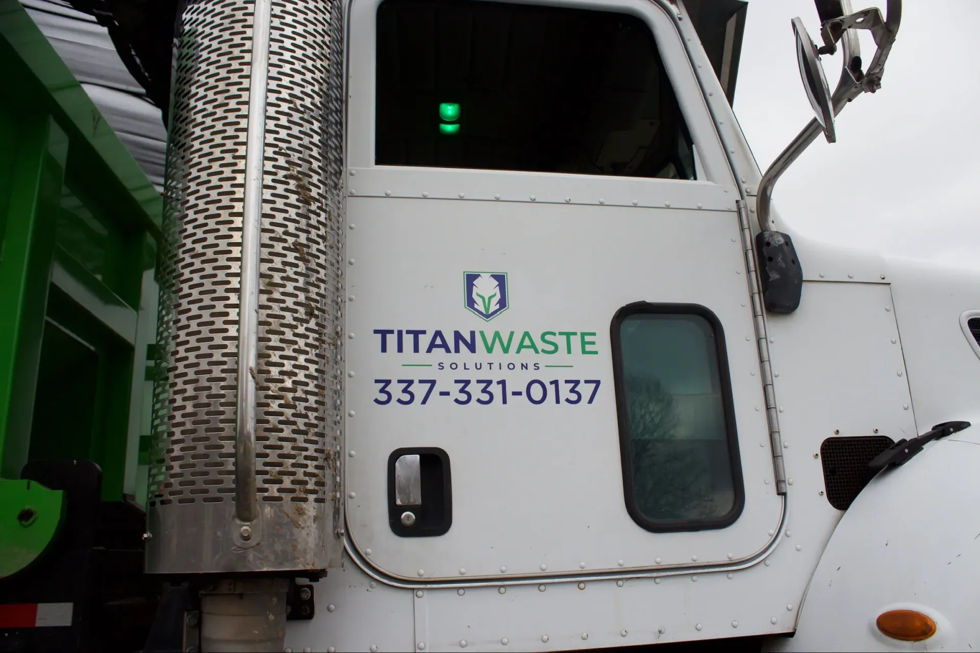 A white truck with titanwaste written on it
