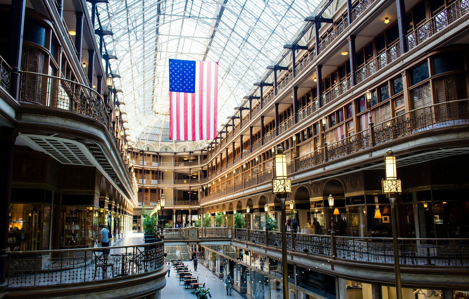 Interior of the Cleveland Arcade, glass ceiling, multiple levels, US flag.