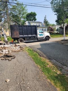 A dump truck is parked on the side of the road