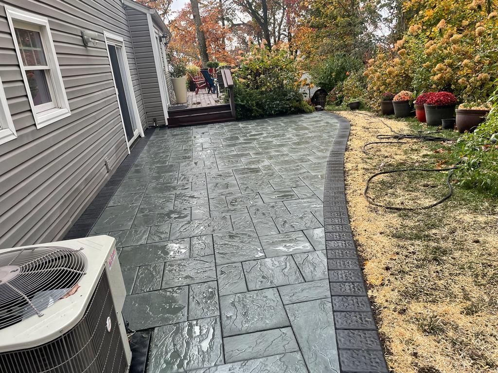 A patio with a air conditioner in the backyard of a house.