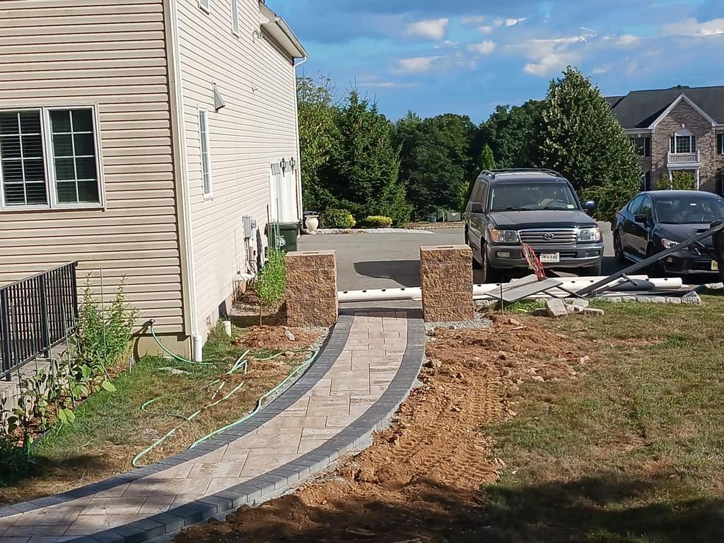 A car is parked on the side of the road next to a house.