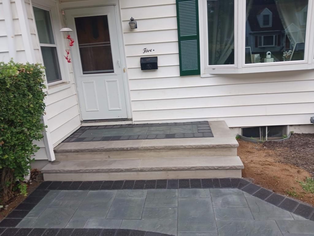 A white house with steps leading up to the front door