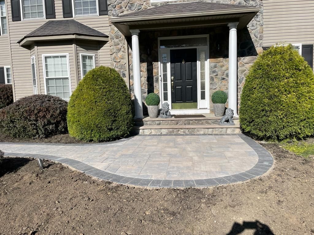 There is a walkway leading to the front door of a house.